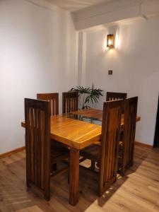 a dining room with a wooden table and chairs at Bunk 7 in Kandy