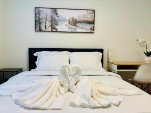 a bedroom with a bed with white socks on it at Your Cozy NL Haven in St. John's