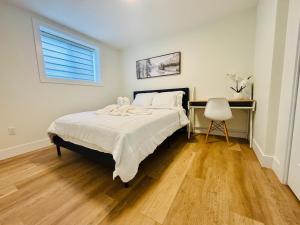a bedroom with a bed and a chair in it at Your Cozy NL Haven in St. John's