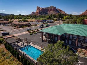 an aerial view of a resort with a pool and mountains at Kokopelli Inn Sedona, Trademark Collection by Wyndham in Sedona