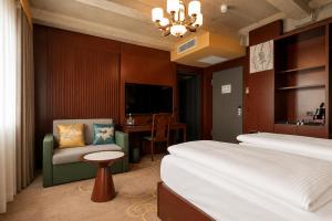 a hotel room with two beds and a chair at Olive INN Berlin in Berlin +33 photos