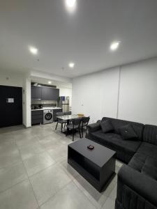 a living room with a couch and a table at Rami Grand Residence in Erbil +15 photos