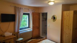 a bedroom with a bed and a window and a television at Campus Hotel - ehemals Hotel Paseo in Aachen