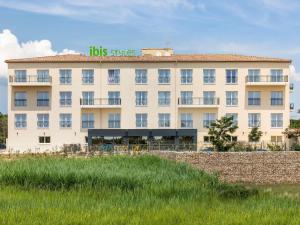 a large white building with a sign on it at Ibis Styles Miramas in Miramas