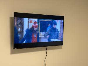 a flat screen tv hanging on a wall at Your Cozy NL Haven in St. John's