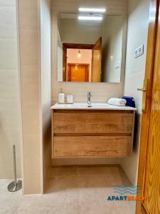 a bathroom with a sink and a mirror at APARTBEACH BALANDRO VISTAS MAR in Cambrils +31 photos