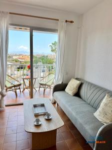 a living room with a couch and a table at APARTBEACH BALANDRO VISTAS MAR in Cambrils