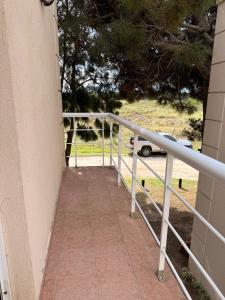 a walkway leading up to a house with a fence at Cabañas Aires del Bosque in Santa Teresita