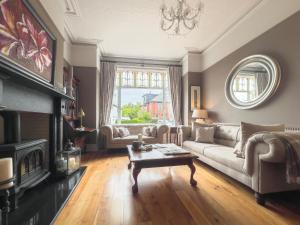 a living room with a couch and a fireplace at Somerton House Rooms Only in Belfast