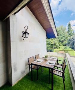 a patio with a table and chairs and a light fixture at Casa Bosques in Mexico City