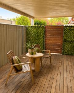 a patio with a table and chairs on a deck at Muswellbrook Motor Inn in Muswellbrook