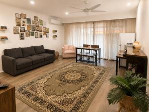 a living room with a couch and a table at Muswellbrook Motor Inn in Muswellbrook