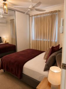 a bedroom with a large bed and a window at Muswellbrook Motor Inn in Muswellbrook