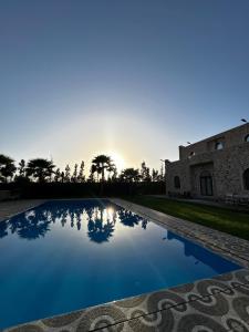 a view of a swimming pool in front of a building at Villa zaytoun in Agadir
