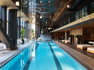 a pool in a hotel with chairs and a couch at Raffles Boston in Boston