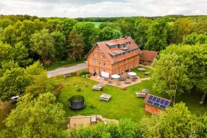 an overhead view of a large brick house with a yard at Hotel Bolter Mühle - DZ Mohnbuchte in Rechlin