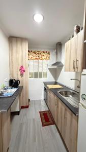 a kitchen with a sink and a counter top at Apto a 5 min a pie de la playa in Málaga