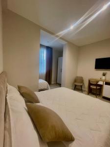 a hotel room with a large bed and a table at Solea Hotel in Vlorë +37 photos