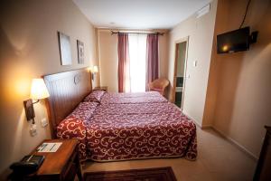 Postel nebo postele na pokoji v ubytování Gran Hotel Ciudad Del Sur