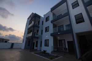 a large white building with a sunset in the background at Stay-city Rans in Apenkwa