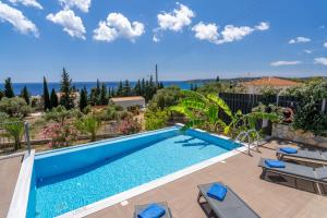 a swimming pool in a villa with a view at Vista Blu Villas in Vlachata