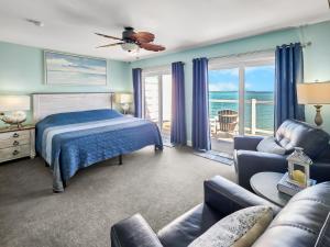 a bedroom with a bed and a couch at Put-in-Bay Waterfront Condo #207 in Put-in-Bay