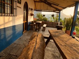 a wooden bench sitting outside of a building at ECOHostal las Hamacas in Villamaría