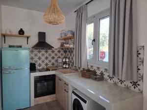 a kitchen with a blue refrigerator and a sink at Rhodes Soul Luxury Suites in Afantou