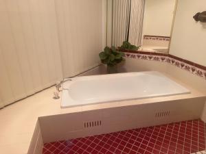 a white bath tub in a bathroom with a mirror at Private Rm4-Queen bed in Elderslie +31 photos