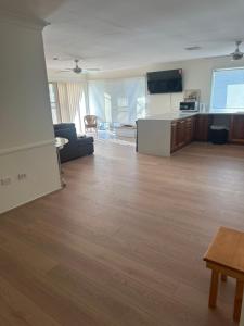 a large room with wooden floors and a living room at Private Rm4-Queen bed in Elderslie
