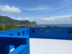 a blue wall with a view of the ocean at Sun Ocean Hachijojima in Hachijo