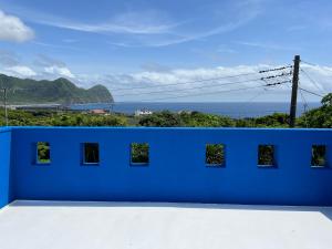 a blue wall with a view of the ocean at Sun Ocean Hachijojima in Hachijo +26 photos
