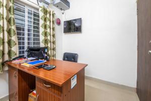 an office with a desk with a computer on it at Hotel O Sagar Comforts in Bangalore