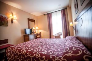 Postel nebo postele na pokoji v ubytování Gran Hotel Ciudad Del Sur