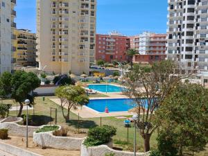 a swimming pool in a city with tall buildings at 2F Sao Gabriel - Casas & Papeis in Armação de Pêra