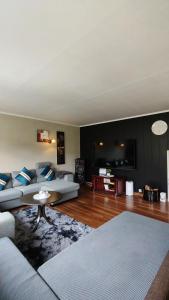 a living room with a couch and a table at Stryn Norway in Stryn