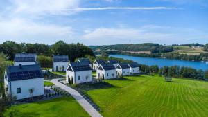an aerial view of a row of houses with a lake at Raduńskie Zacisze in Chmielno