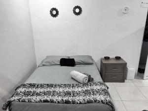a bed in a bedroom with two mirrors on the wall at La Isla Studio - Quimixto in Qumiste