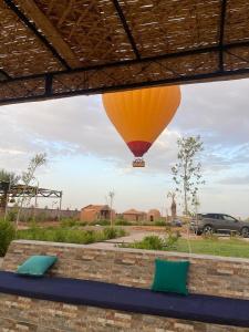 a hot air balloon is flying in the sky at Dômes et Bangalows traditionnel in Marrakesh