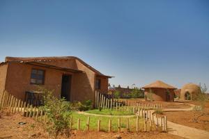 a small house with a fence in front of it at Dômes et Bangalows traditionnel in Marrakesh