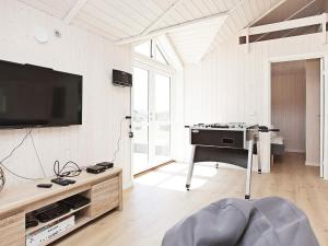 a living room with a flat screen tv on a wall at Luxury Retreat with Spa - By Traum Ferienwohnungen in Bøtø By