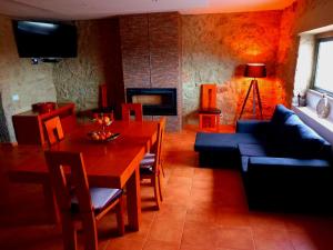 a living room with a table and a blue couch at Solar do Prazo-Serra & Charme in Gonçalo
