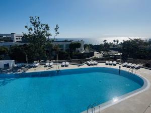a swimming pool with a view of the ocean at KAI Apartment Playa Paraiso in Playa Paraiso