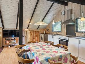 a dining room with a table and chairs in a kitchen at 5 person holiday home in Dannemare in Dannemare