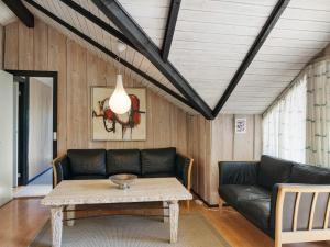 a living room with a couch and a table at 5 person holiday home in Dannemare in Dannemare