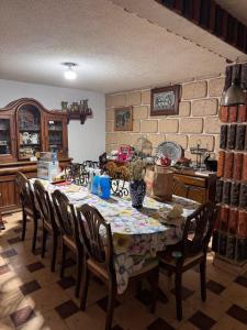 a kitchen with a table and chairs in a room at Mexican House in Mexico City