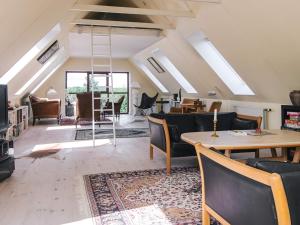 a living room with couches and a table and chairs at 4 star holiday home in Hornsyld in Hornsyld
