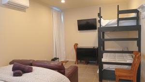 a living room with a bunk bed and a couch at The Central Apartment in Geraldine