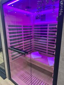 a purple room with purple lighting in a store at L'annexe étoilée in Couvin