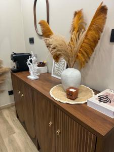 a wooden cabinet with a vase on top of it at L'annexe étoilée in Couvin